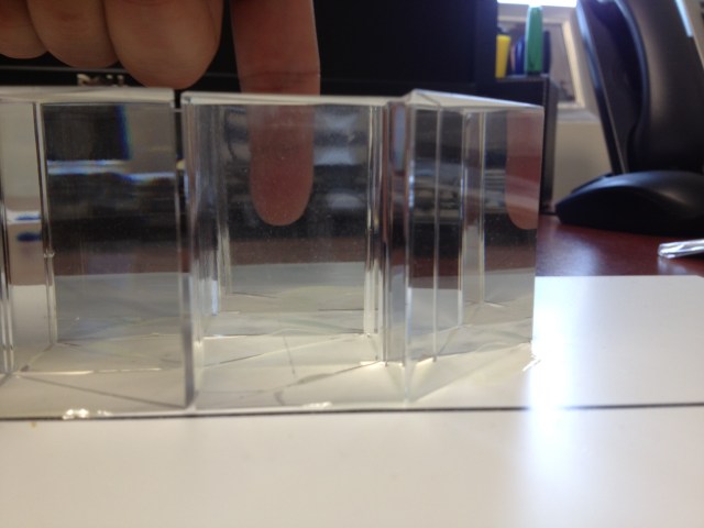 A finger behind the prism cloak -- readily visible with little distortion.