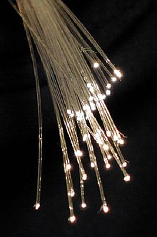 The end of a bundle of fiber optic cables, showing the light emerging.  Via Wikipedia.