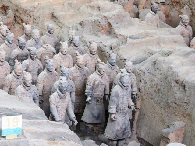 Officer leading a formation of soldiers.